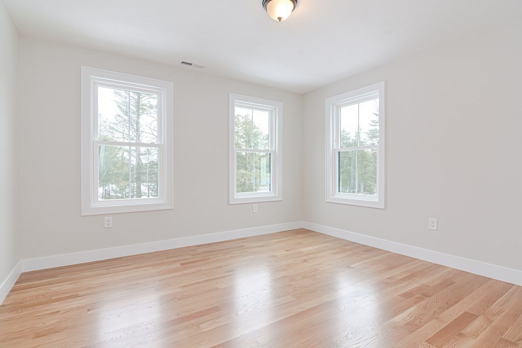 Lot 7 Maple Avenue Groton, MA 01450 - Photo 23 of 42 a view of an empty room with wooden floor and a window