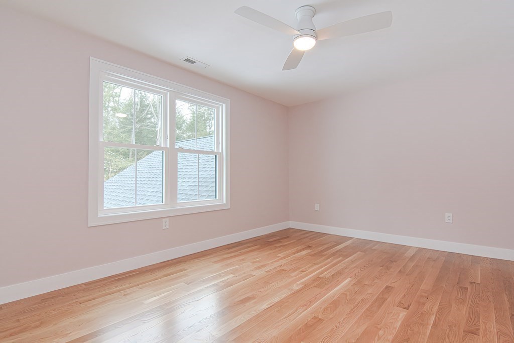 Lot 7 Maple Avenue Groton, MA 01450 - Photo 28 of 42 an empty room with wooden floor fan and windows