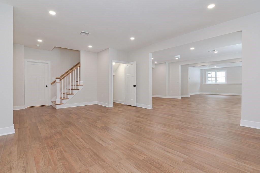Lot 7 Maple Avenue Groton, MA 01450 - Photo 33 of 42 a view of an empty room with wooden floor and staircase
