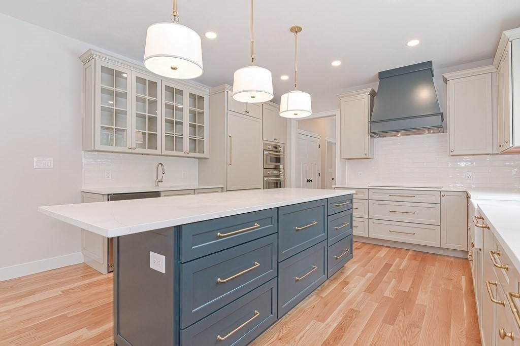 Lot 7 Maple Avenue Groton, MA 01450 - Photo 5 of 42 a kitchen with a sink dishwasher a dining table and chairs with wooden floor