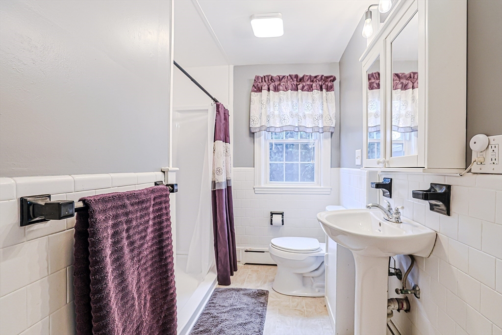 9 Russ Street Methuen, MA 01844 - Photo 14 of 37 a bathroom with a toilet sink and mirror