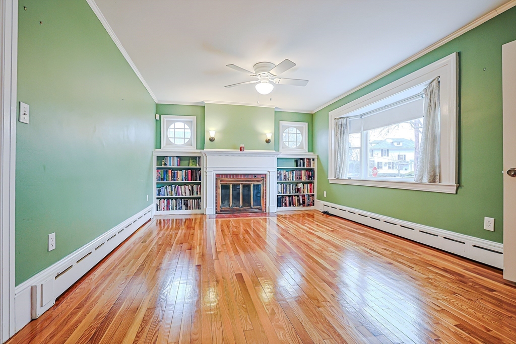 9 Russ Street Methuen, MA 01844 - Photo 3 of 37 an empty room with wooden floor fireplace and a window