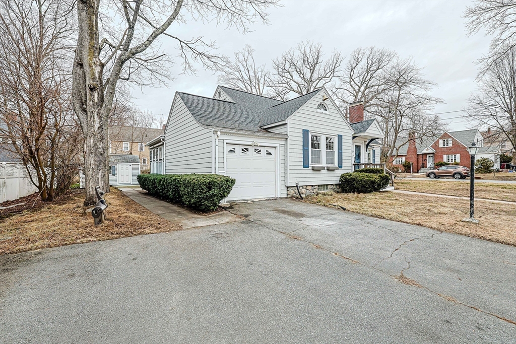 9 Russ Street Methuen, MA 01844 - Photo 33 of 37 a front view of a house with a yard and garage
