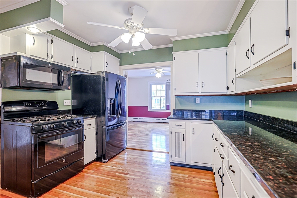 9 Russ Street Methuen, MA 01844 - Photo 9 of 37 a kitchen with stainless steel appliances granite countertop a stove a sink and a refrigerator