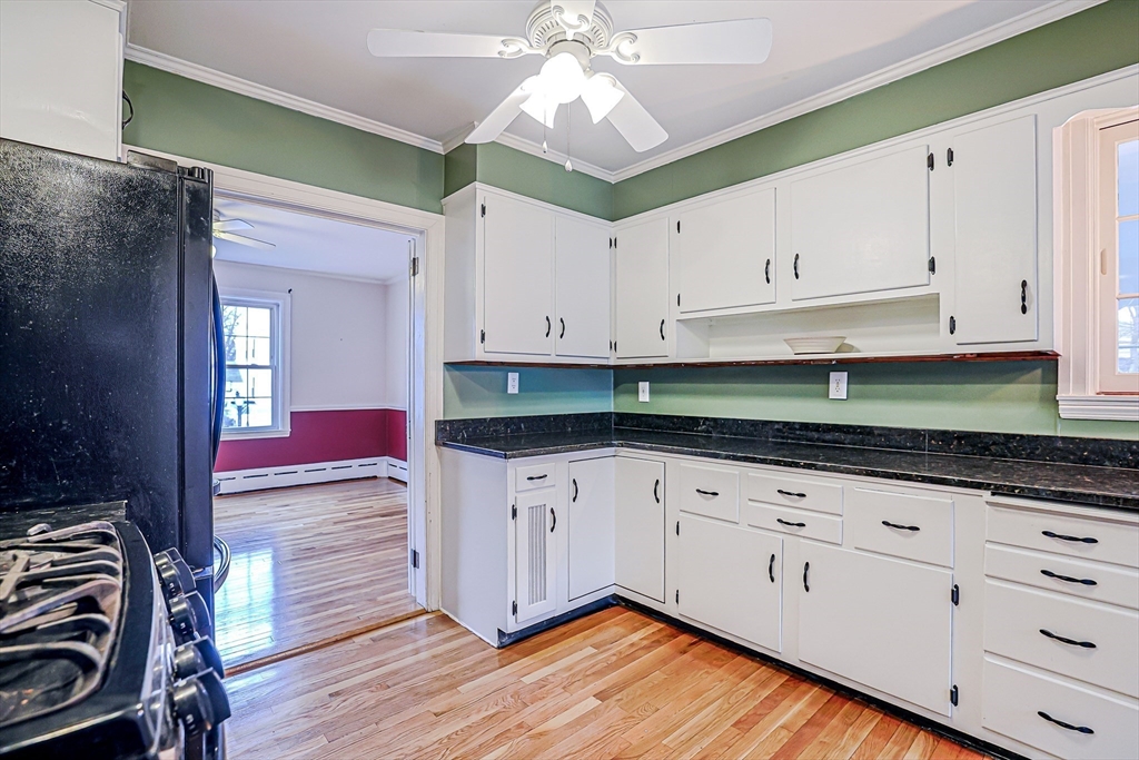 9 Russ Street Methuen, MA 01844 - Photo 10 of 37 a kitchen with granite countertop white cabinets and white appliances