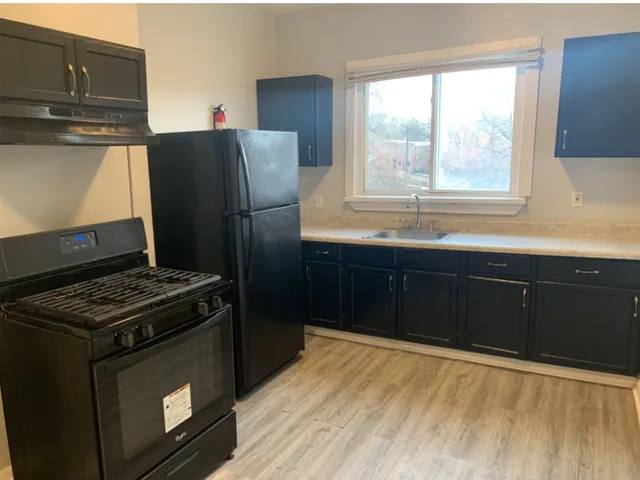 a kitchen with granite countertop a stove and a refrigerator
