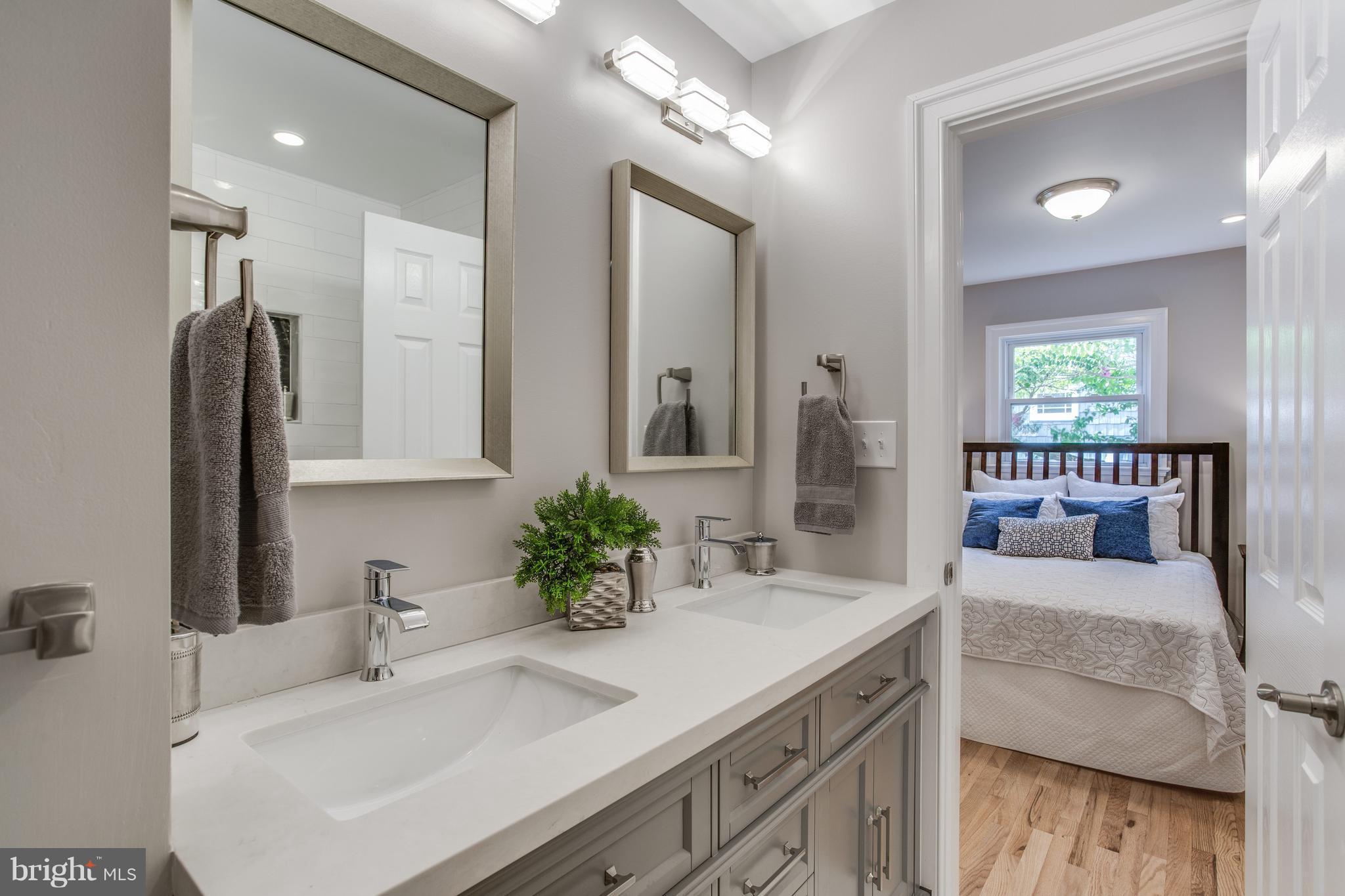 7017 Quander Road Alexandria, VA 22307 - Photo 13 of 30 a en suite bathroom with double vanity and a mirror