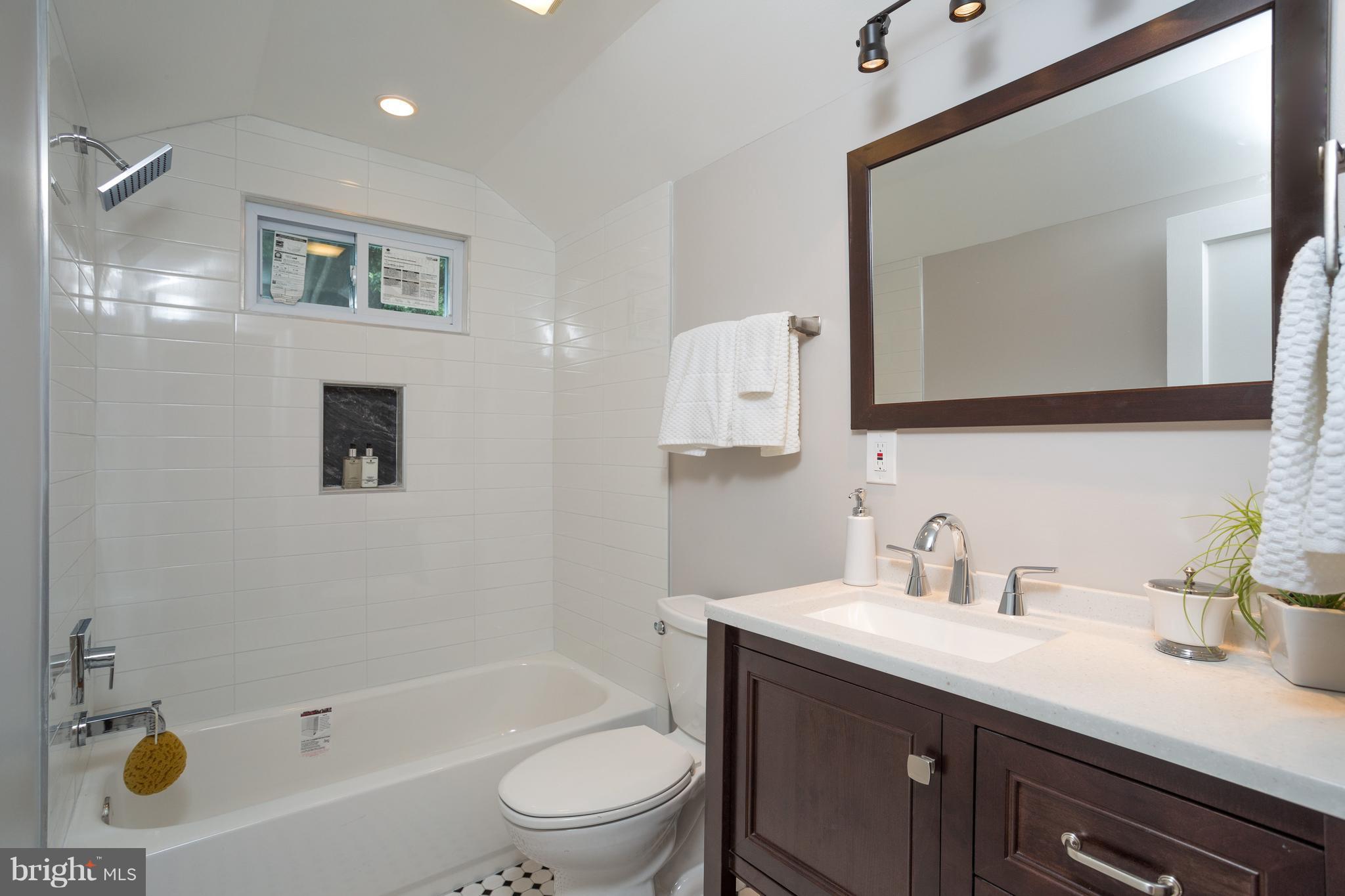 7017 Quander Road Alexandria, VA 22307 - Photo 21 of 30 a bathroom with a sink a toilet and shower