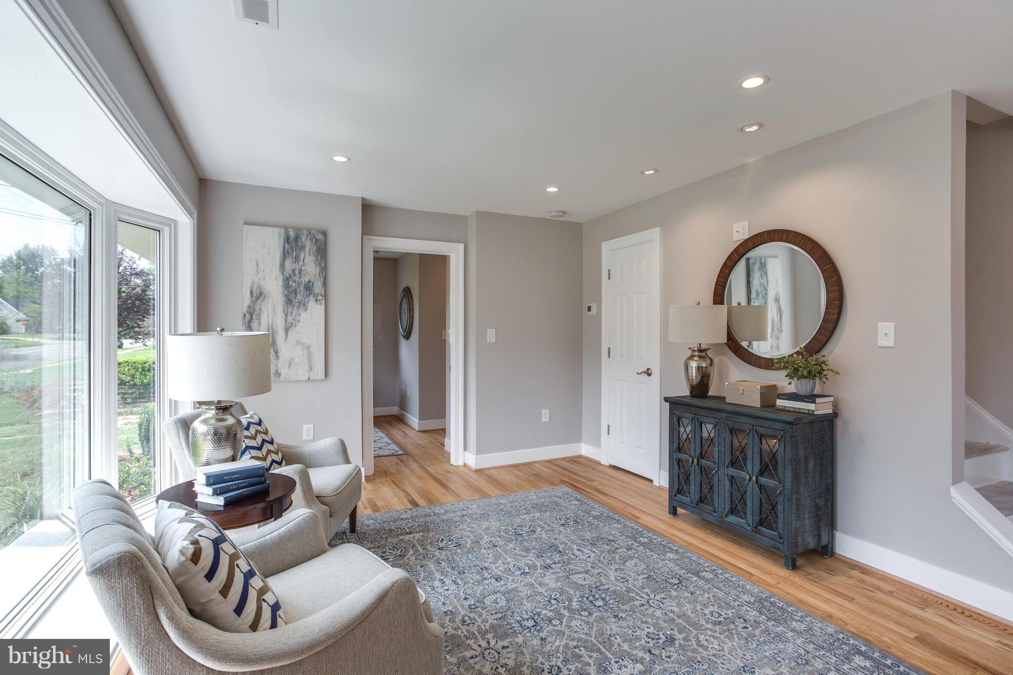 7017 Quander Road Alexandria, VA 22307 - Photo 6 of 30 a living room with furniture a rug a mirror and a rug