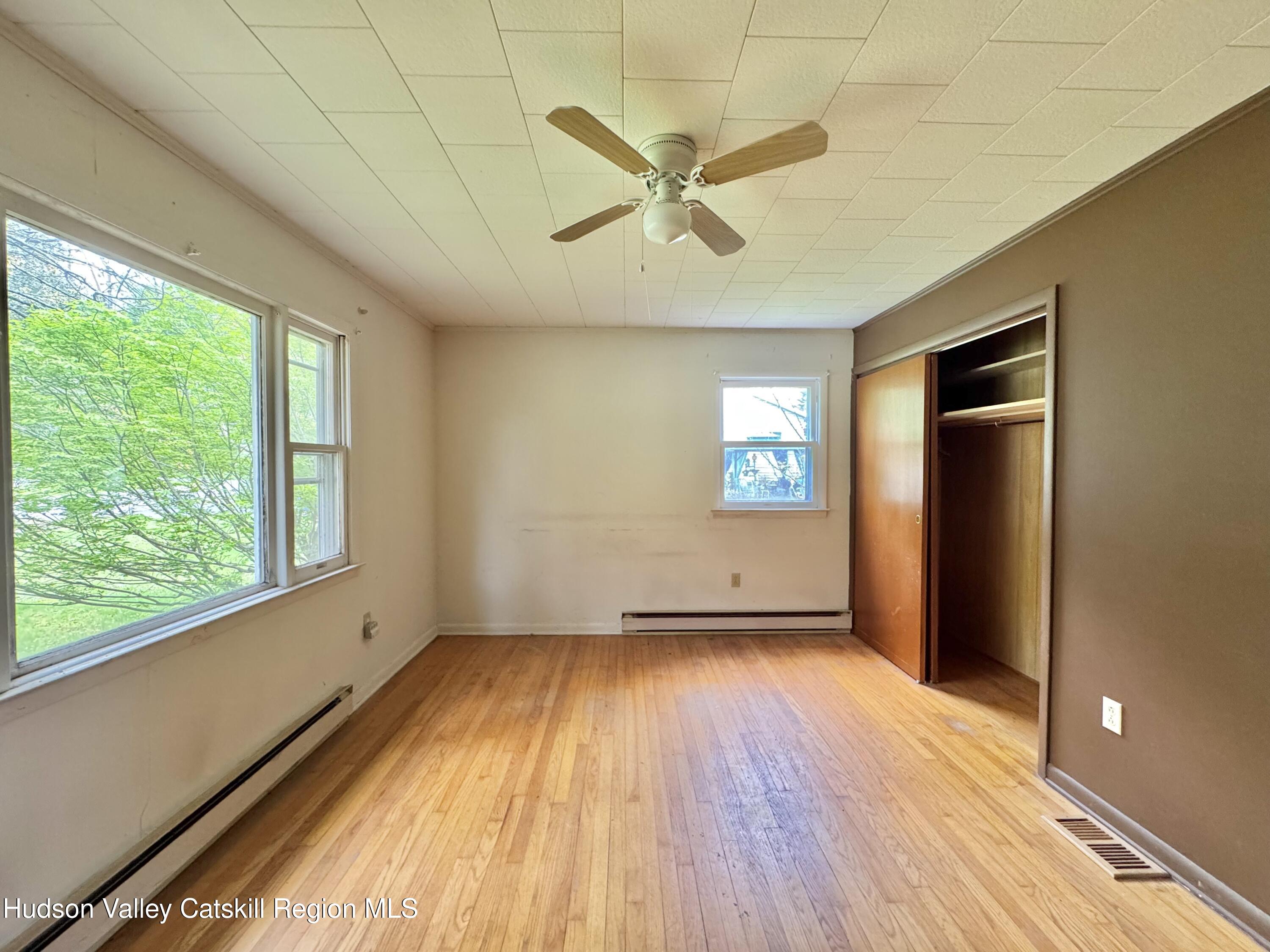 752 Old Rte 23 Acra, NY 12405 - Photo 14 of 25 wooden floor in an empty room with a window