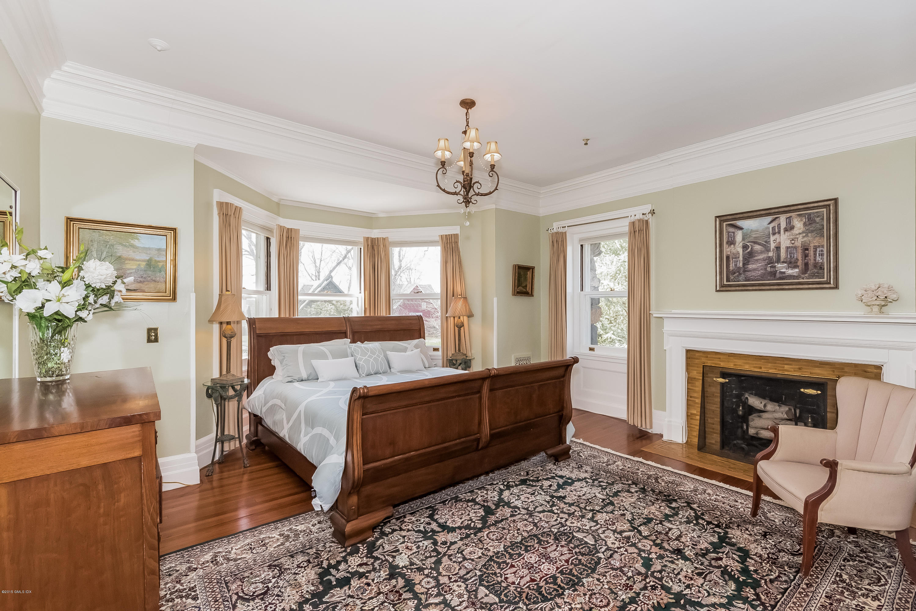 432 Field Point Road Greenwich, CT 06830 - Photo 18 of 25 a bed room with a bed and a fireplace