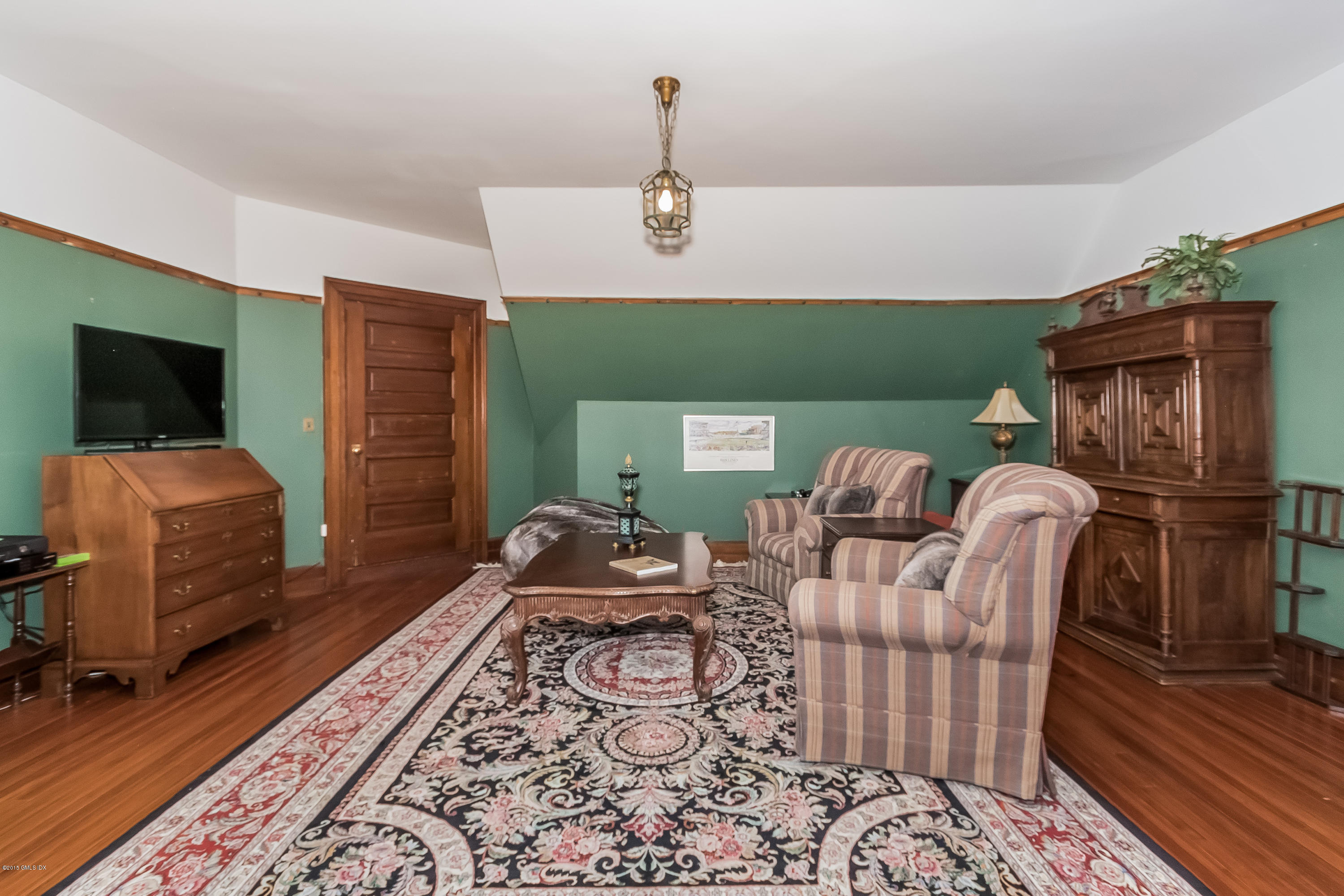 432 Field Point Road Greenwich, CT 06830 - Photo 22 of 25 a bedroom with furniture and a wooden floor