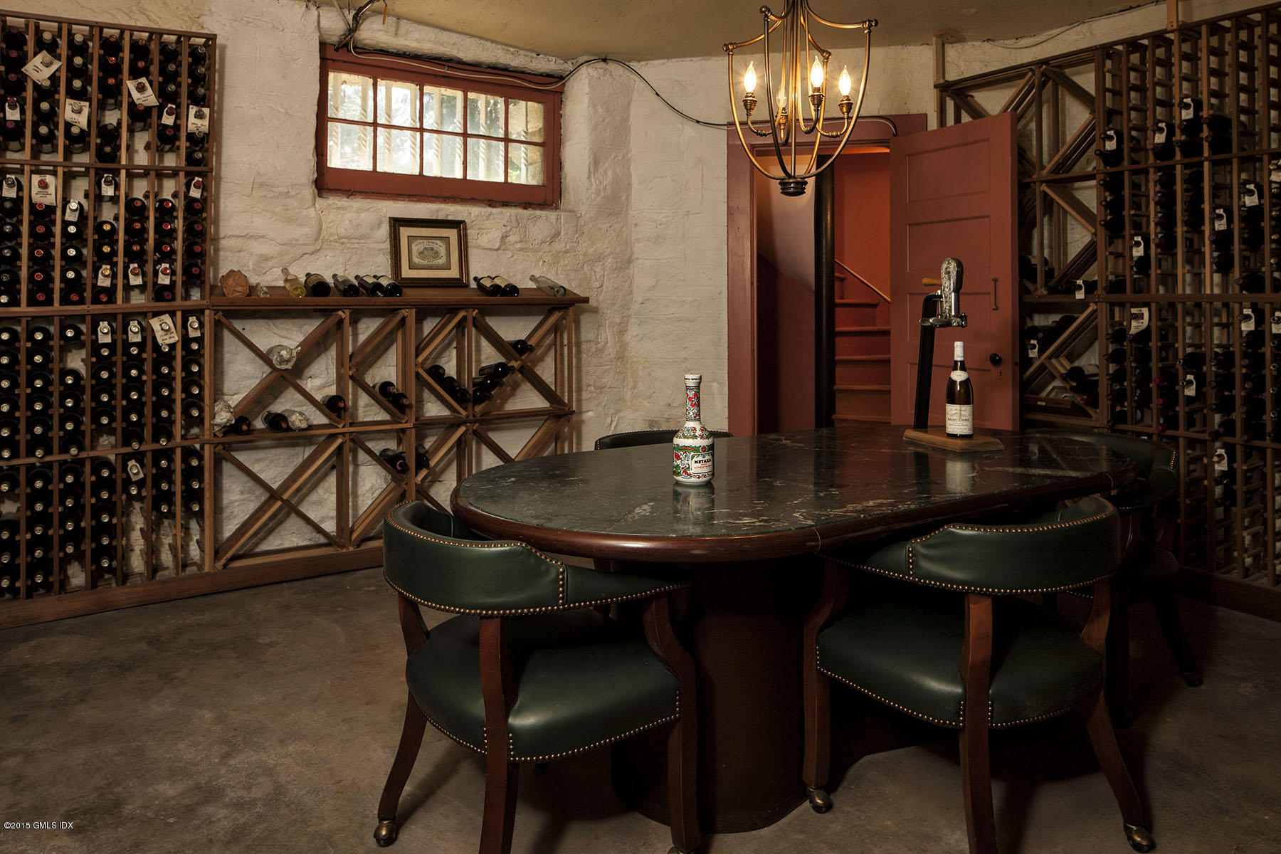 432 Field Point Road Greenwich, CT 06830 - Photo 23 of 25 a view of a dining room with furniture and chandelier