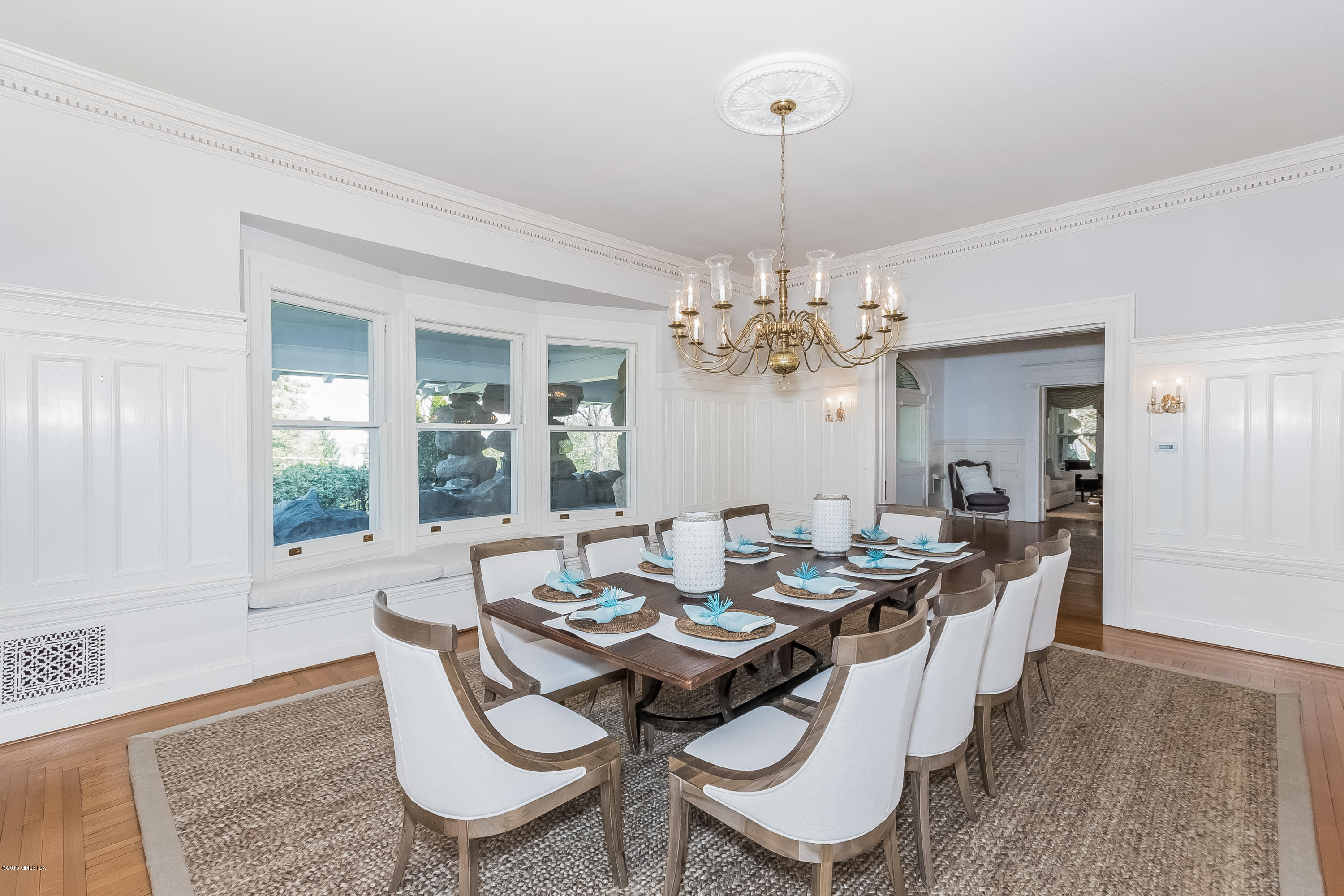 432 Field Point Road Greenwich, CT 06830 - Photo 9 of 25 a dining room with furniture a chandelier and wooden floor