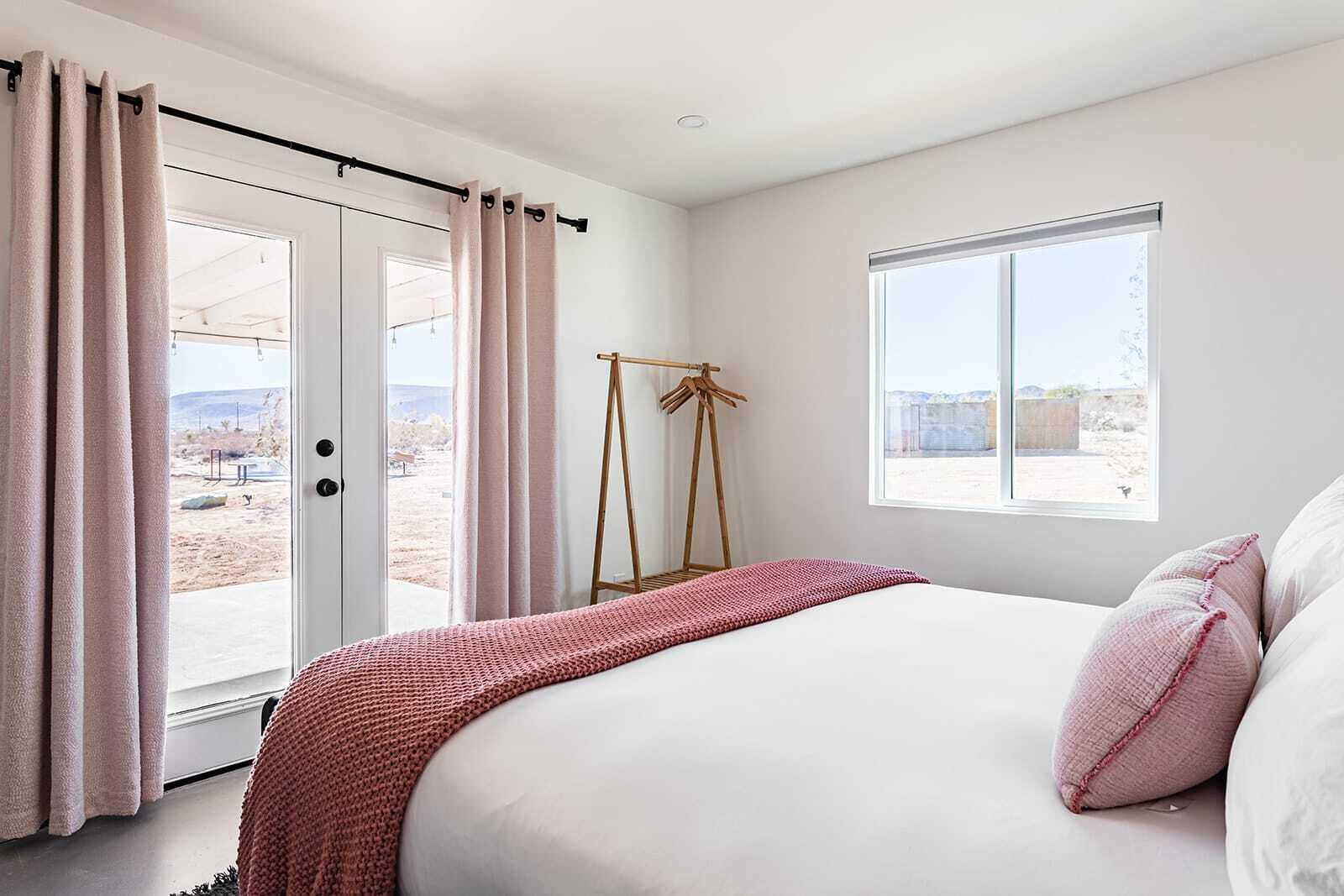 55717 Ruth Lane Yucca Valley, CA 92284 - Photo 24 of 32 a bedroom with a bed and a window