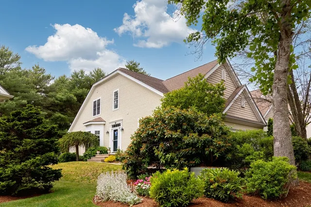 a view of a house with a yard and garden