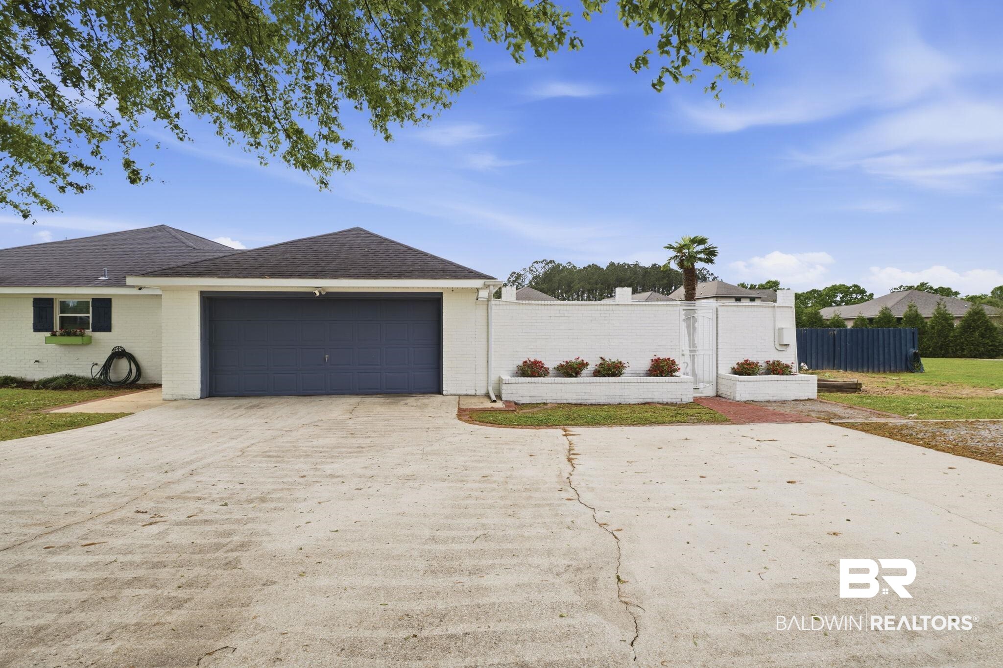10670 Jeff Hamilton Road Mobile, AL 36695 - Photo 11 of 43 View of front facade featuring brick siding, a garage, driveway, and a shingled roof