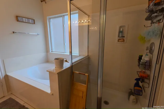 a bathroom with a sink a mirror and shower