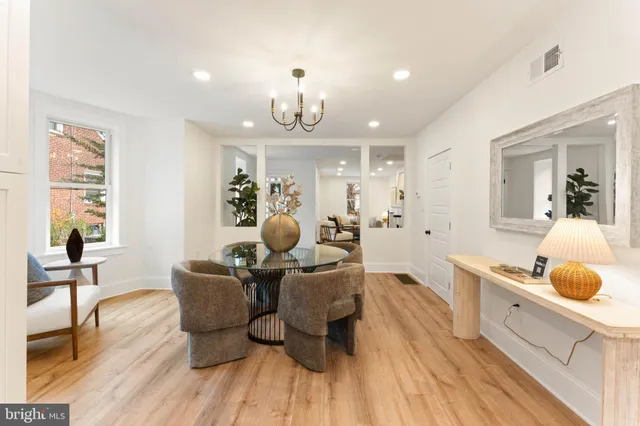 a living room with furniture a dining table and kitchen view
