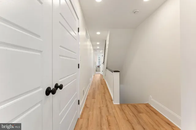 a view of a hallway with wooden floor