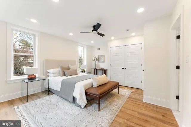 a bedroom with a large bed and a chandelier