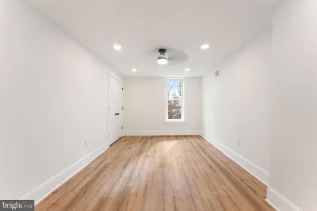 a view of an empty room with wooden floor