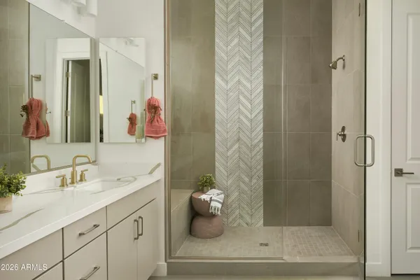 a bathroom with a double vanity sink mirror and shower