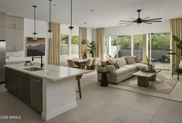 a kitchen with stainless steel appliances granite countertop a sink and a refrigerator