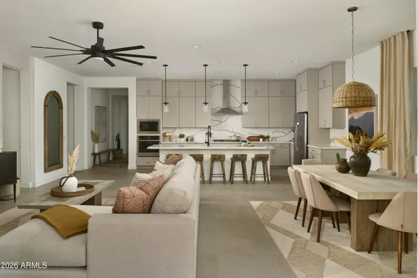 a living room with furniture a large window and a chandelier