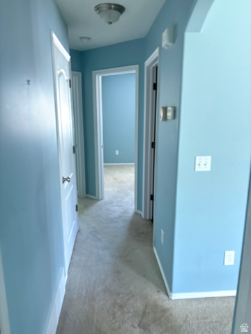 587 West 2400 South Perry, UT 84302 - Photo 28 of 46 Carpeted hallway with light blue wall paint and white trim