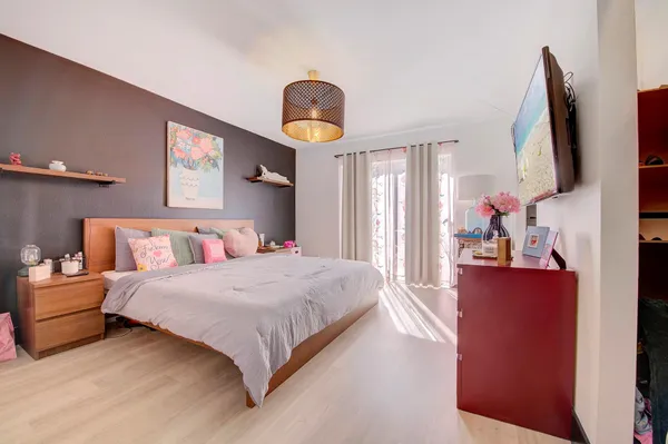 a bedroom with a bed and a flat screen tv