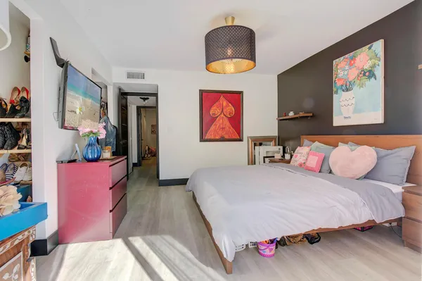 a bedroom with bed and a couch