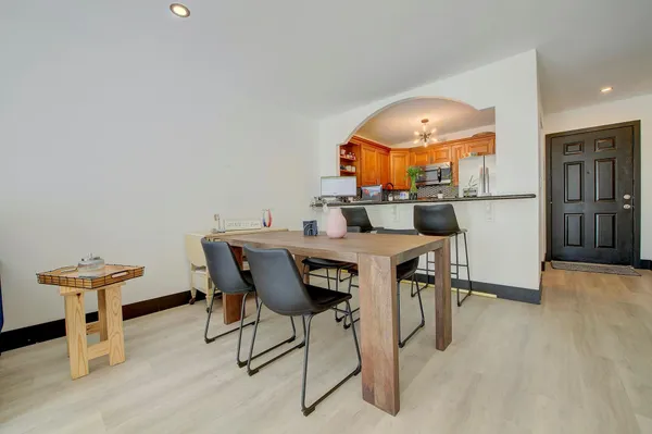 a view of a dining room with furniture and a chandelier