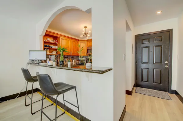 a dining room with furniture and a chandelier