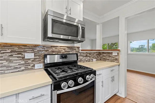 a kitchen with stainless steel appliances a refrigerator and a stove top oven