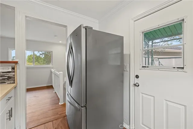 a kitchen with stainless steel appliances a refrigerator and a stove top oven