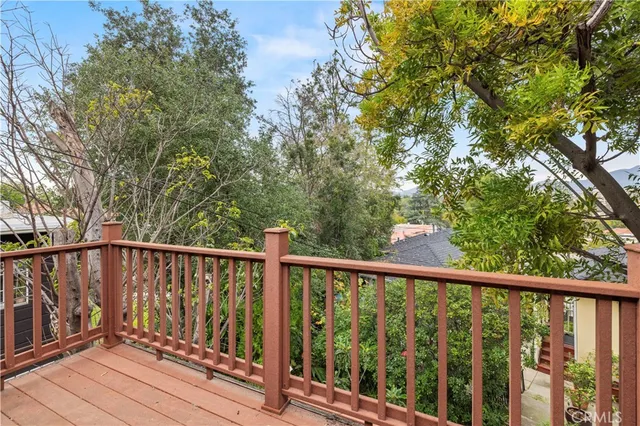 a view of balcony with wooden floor and fence