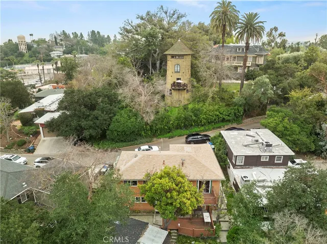 an aerial view of a house with a yard and lake view