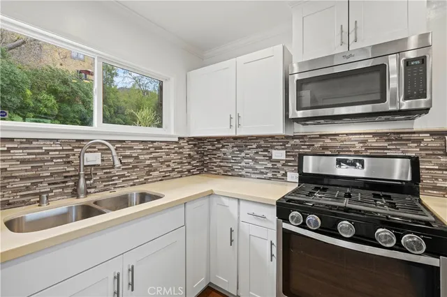 a kitchen with a stove and a sink