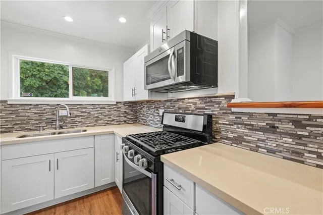 a kitchen with a stove and a sink