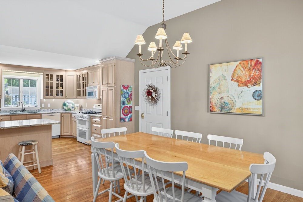 3 Stephen Hopkins Road Harwich, MA 02645 - Photo 16 of 42 a view of a dining room with furniture a chandelier and wooden floor