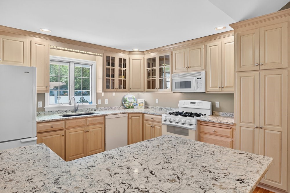 3 Stephen Hopkins Road Harwich, MA 02645 - Photo 18 of 42 a kitchen with stainless steel appliances granite countertop a stove sink and cabinets