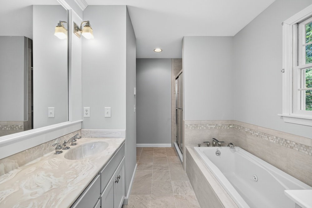 3 Stephen Hopkins Road Harwich, MA 02645 - Photo 23 of 42 a bathroom with a granite countertop tub a double vanity sink and mirror