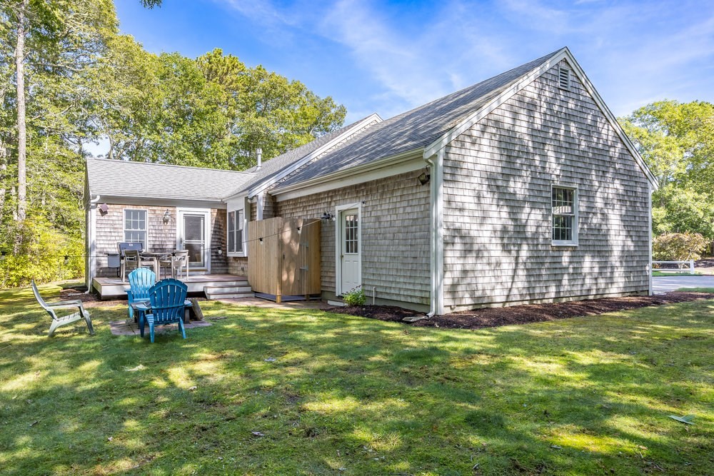 3 Stephen Hopkins Road Harwich, MA 02645 - Photo 35 of 42 a backyard of a house with yard and outdoor seating