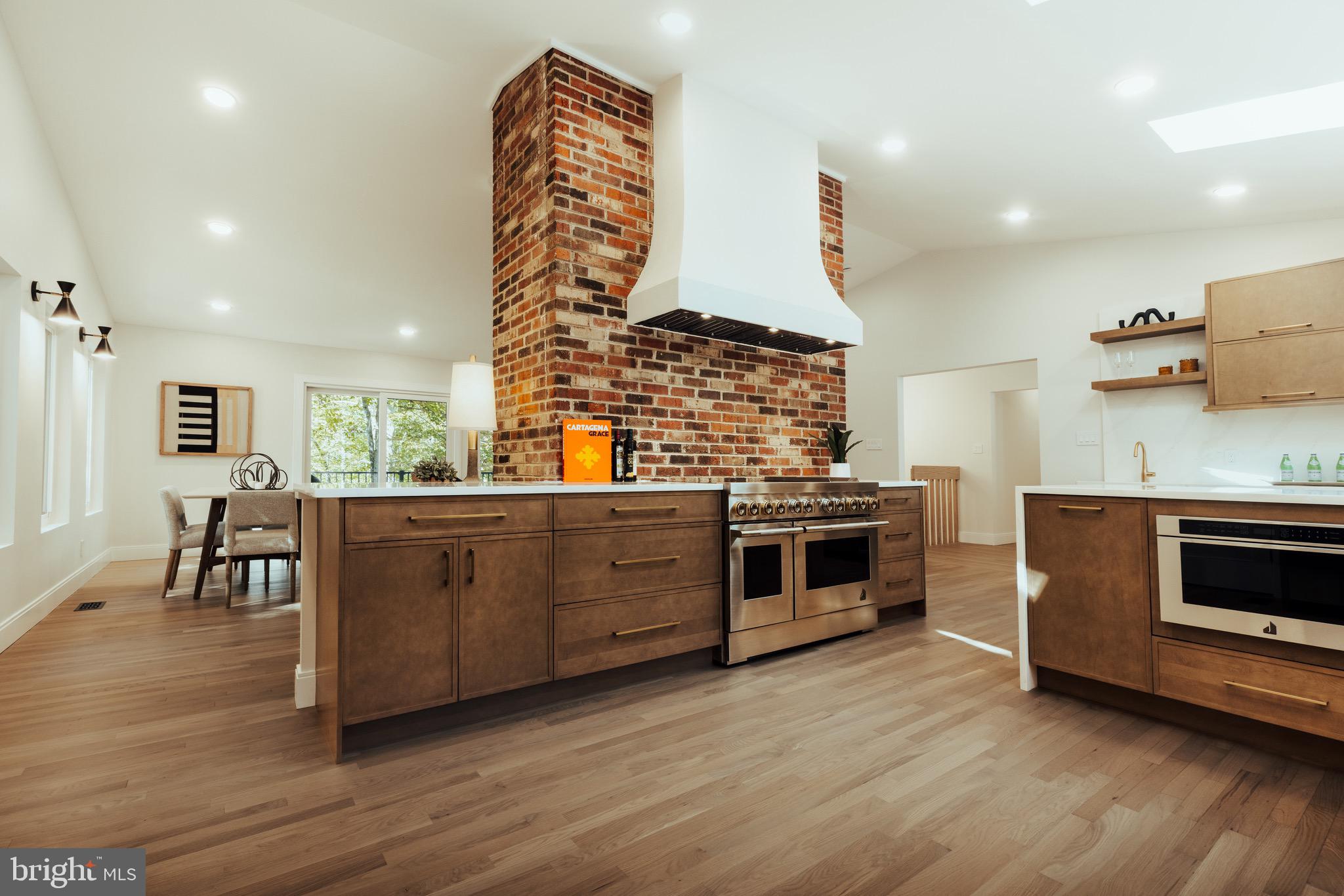 108 Interpromontory Road Great Falls, VA 22066 - Photo 3 of 108 a kitchen with stainless steel appliances kitchen island wooden cabinets and stove