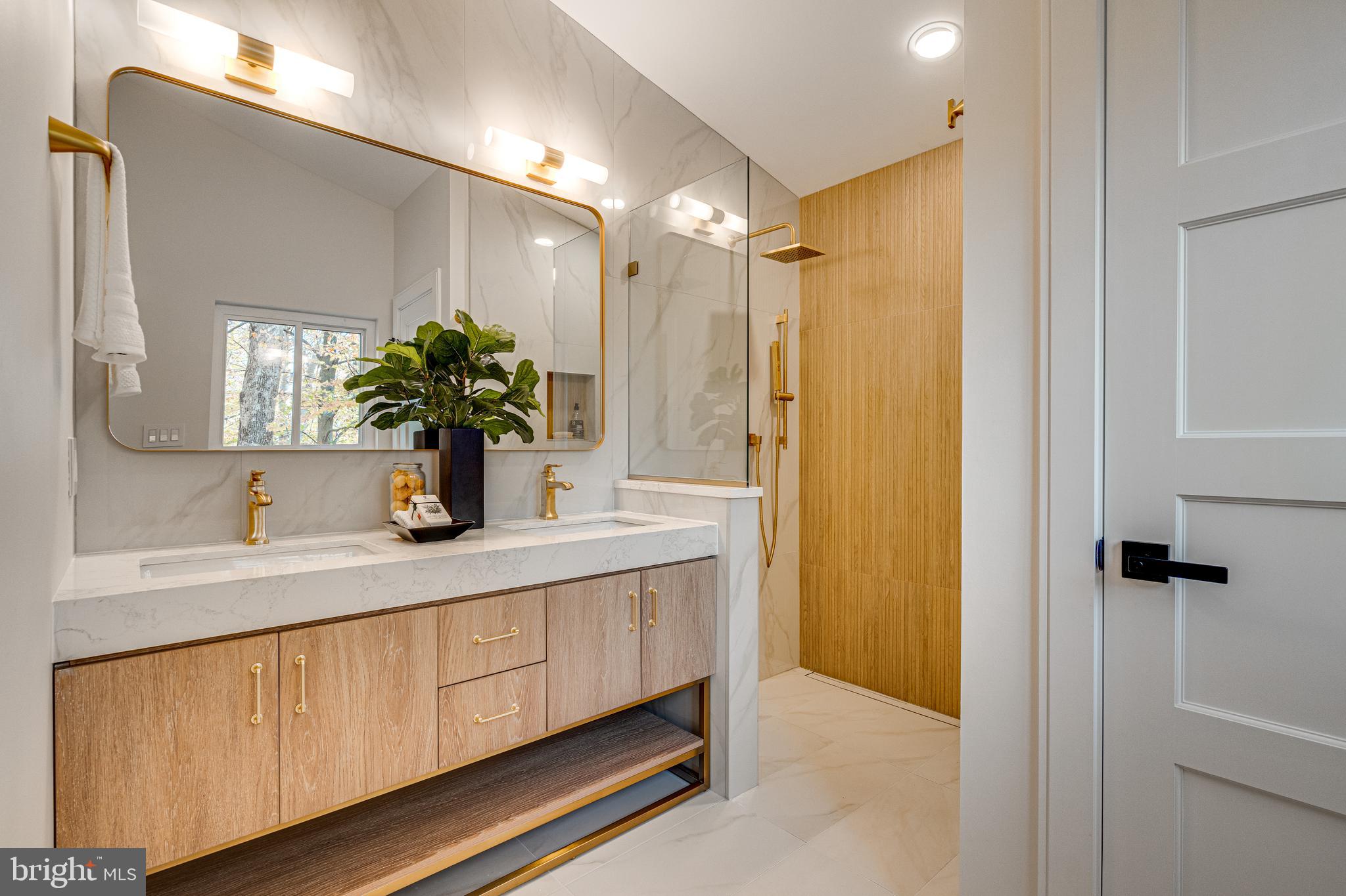 108 Interpromontory Road Great Falls, VA 22066 - Photo 46 of 93 a bathroom with a double vanity sink a mirror and a shower