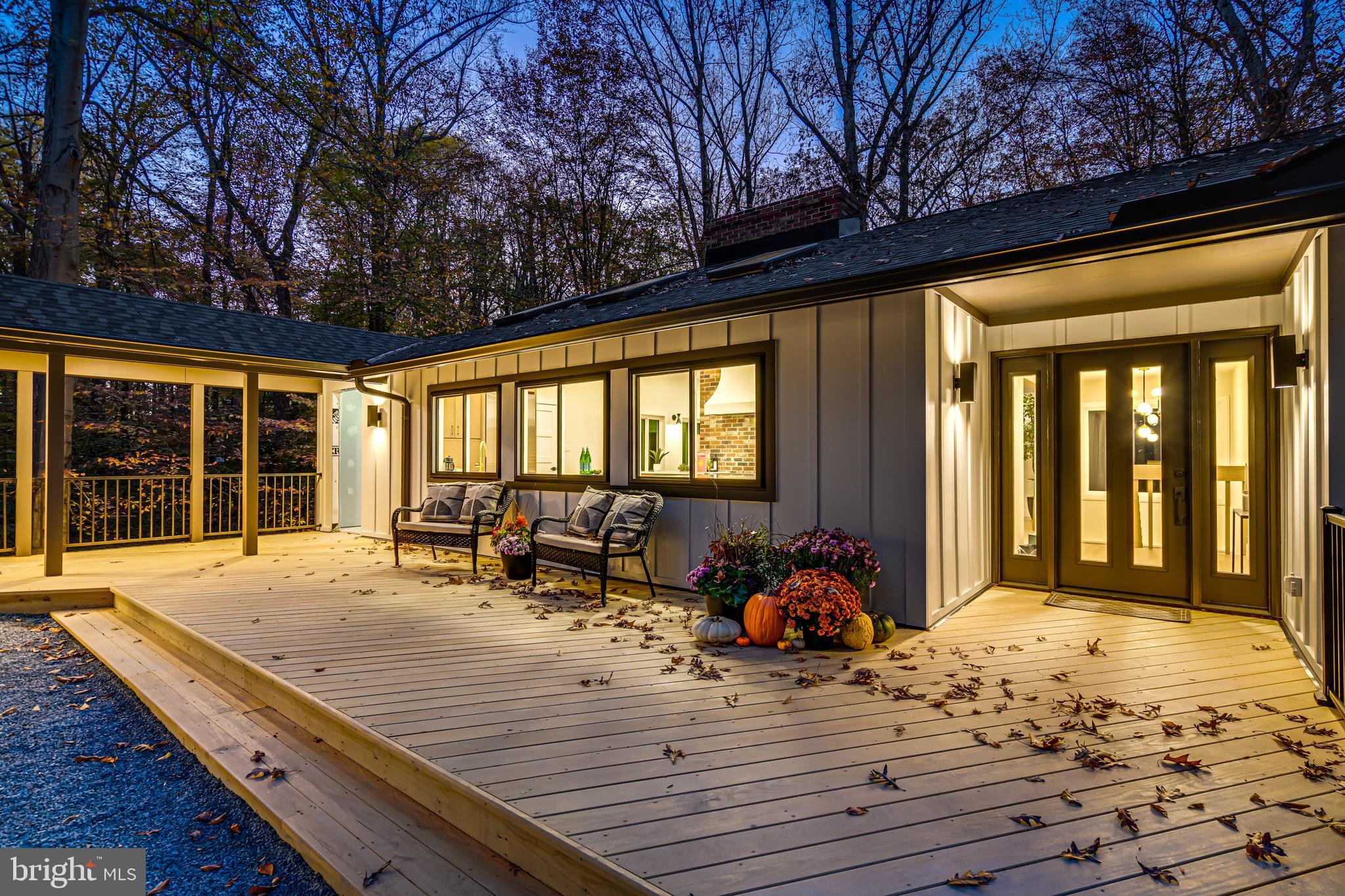 108 Interpromontory Road Great Falls, VA 22066 - Photo 88 of 93 a outdoor space with the couches and dining table with wooden floor