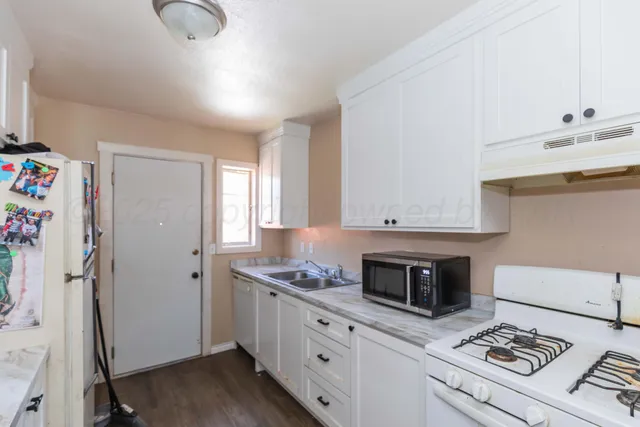 a kitchen with stainless steel appliances granite countertop a stove a refrigerator and a stove