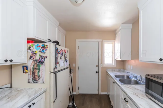 a kitchen with a refrigerator and a sink
