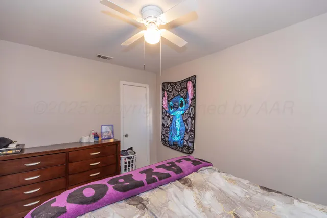 a bedroom with a bed and a dresser